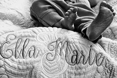 Newborn baby on name blanket